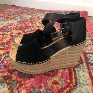 Black wedges with ankle buckle.